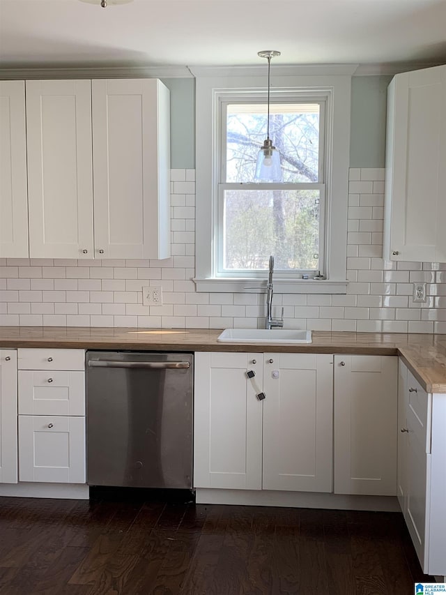 kitchen featuring backsplash, dark wood-type flooring, stainless steel dishwasher, white cabinetry, and a sink