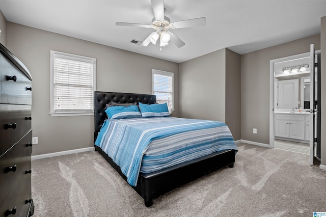 bedroom featuring baseboards, visible vents, a ceiling fan, connected bathroom, and light colored carpet