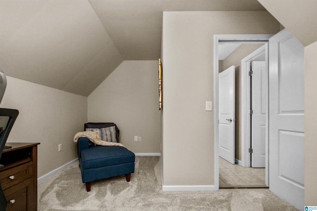 living area featuring light carpet, baseboards, and lofted ceiling