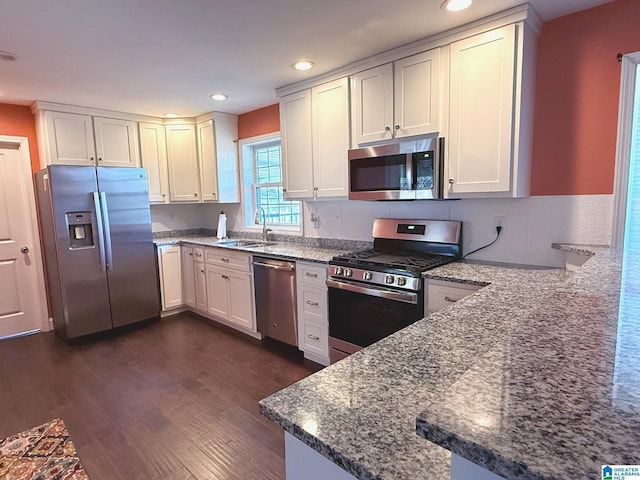 kitchen featuring white cabinetry, stone counters, and appliances with stainless steel finishes