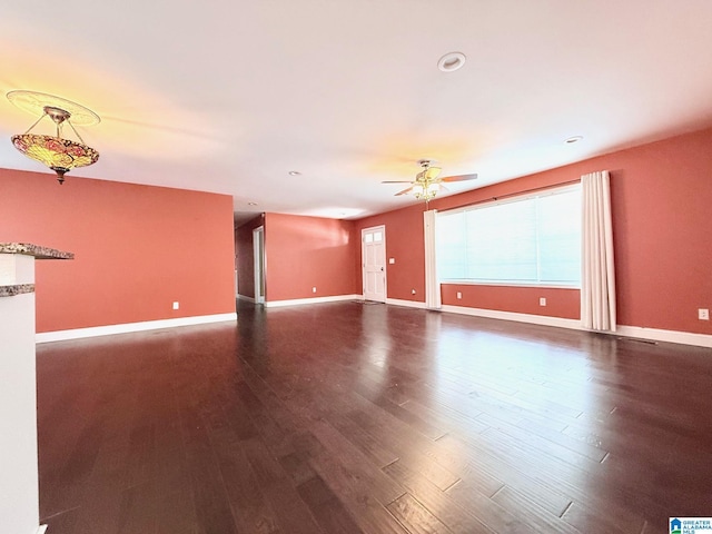 empty room with dark wood-type flooring and ceiling fan