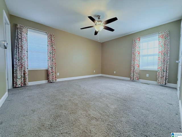 unfurnished room featuring ceiling fan and carpet flooring