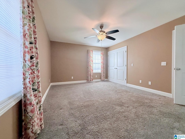 unfurnished bedroom featuring carpet floors, ceiling fan, and a closet