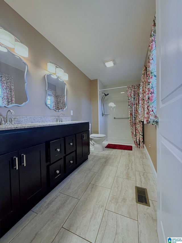 bathroom featuring walk in shower, vanity, and toilet