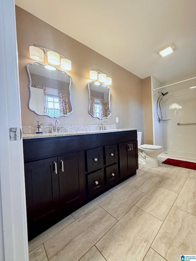 bathroom featuring vanity, a shower, and toilet