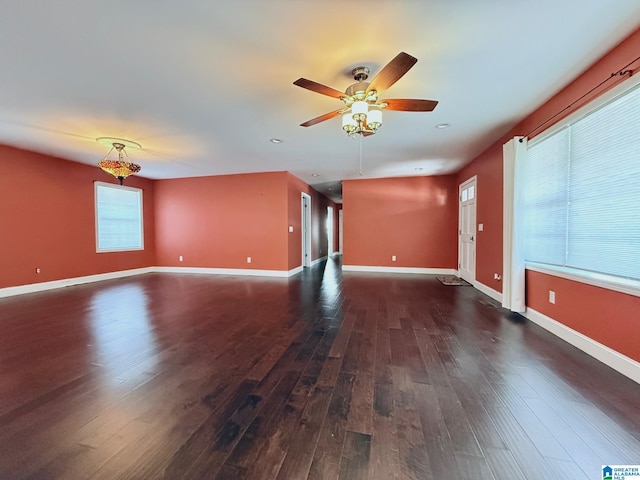 unfurnished living room featuring dark hardwood / wood-style floors and ceiling fan