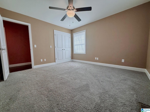 unfurnished bedroom with ceiling fan, carpet floors, and a closet