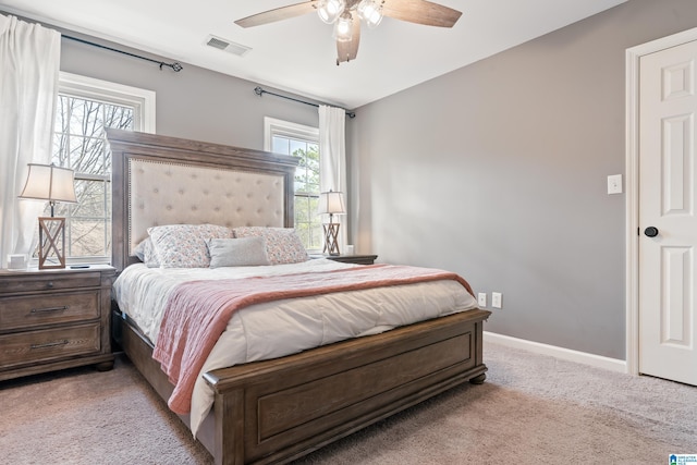 bedroom featuring light colored carpet and ceiling fan