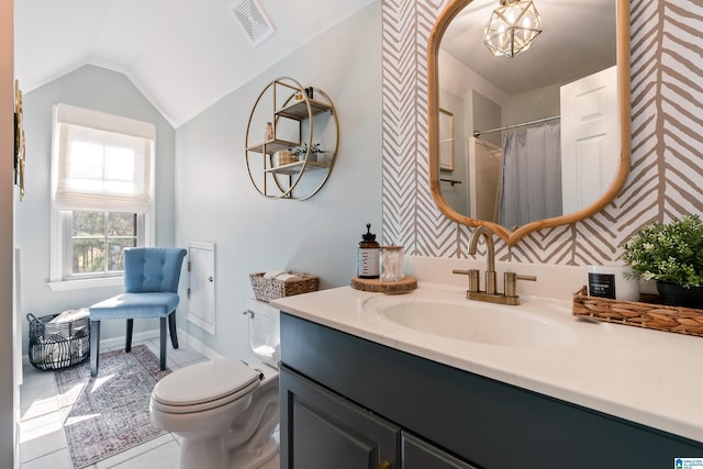 bathroom featuring vanity, lofted ceiling, curtained shower, and toilet