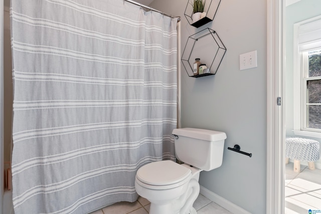 bathroom featuring tile patterned floors and toilet