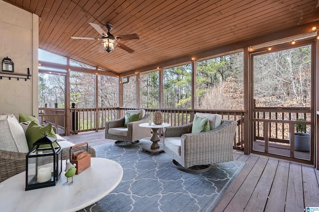 sunroom / solarium featuring wood ceiling, vaulted ceiling, and ceiling fan