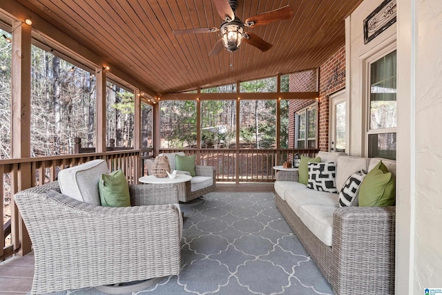 sunroom featuring wood ceiling, ceiling fan, and vaulted ceiling