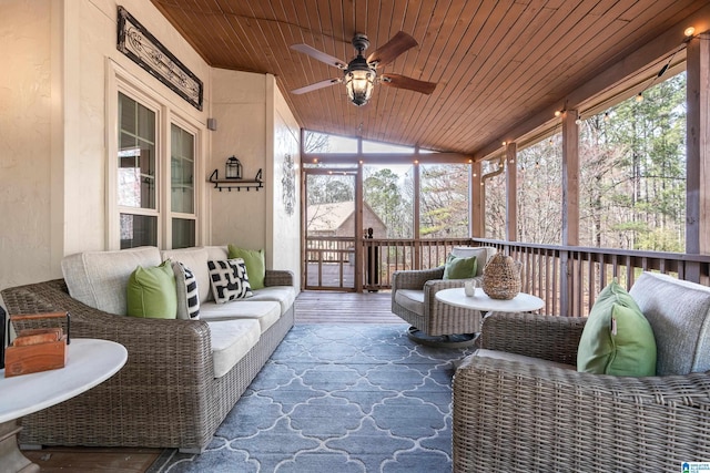 sunroom / solarium with wood ceiling, vaulted ceiling, and ceiling fan