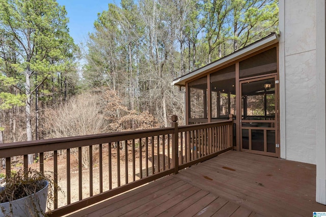 wooden deck with a sunroom