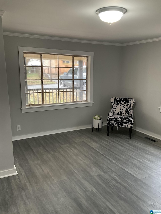 unfurnished room with dark wood-type flooring, ornamental molding, and a healthy amount of sunlight