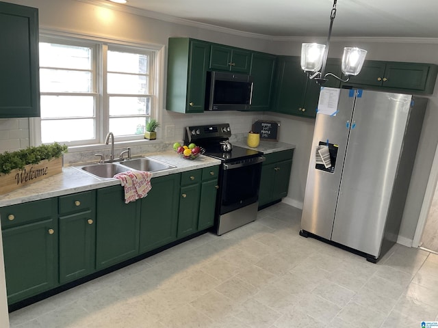 kitchen featuring appliances with stainless steel finishes, sink, backsplash, and green cabinetry