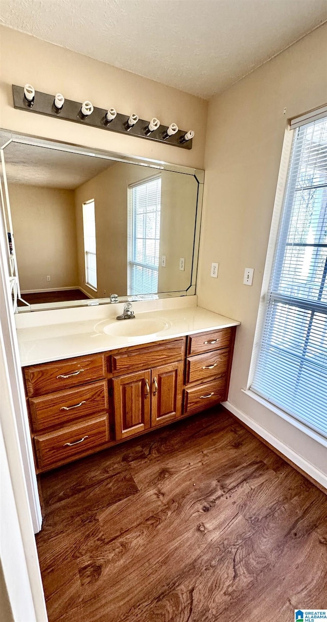 bathroom featuring vanity, hardwood / wood-style flooring, and a textured ceiling