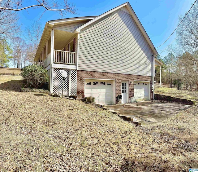 view of home's exterior with a garage and ac unit