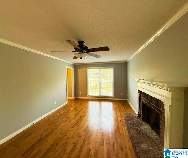 unfurnished living room with crown molding, a brick fireplace, and wood-type flooring