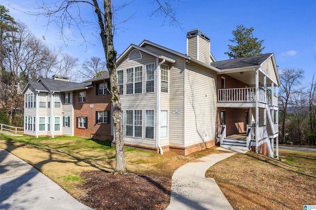 exterior space with a yard and a balcony