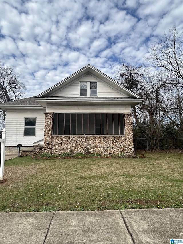 view of side of home featuring a yard