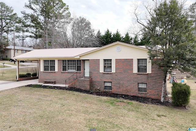 view of front of house with a front yard and a carport