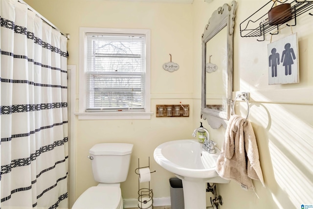 bathroom with a shower with curtain and toilet