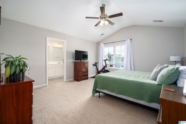 bedroom featuring light carpet, vaulted ceiling, ceiling fan, and ensuite bathroom