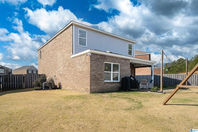 back of house with a lawn