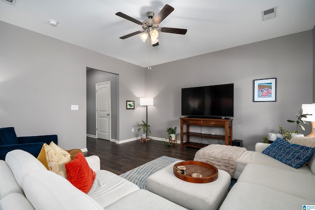 living room featuring dark wood-type flooring and ceiling fan