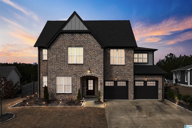 view of front of property with concrete driveway, brick siding, board and batten siding, and an attached garage