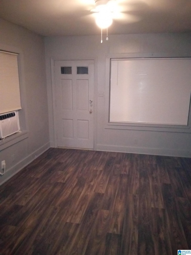 unfurnished room with cooling unit and dark hardwood / wood-style flooring