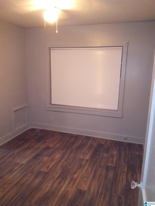 empty room with dark hardwood / wood-style flooring