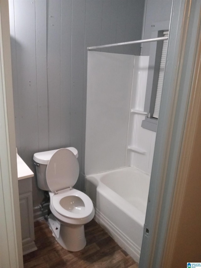 full bathroom featuring vanity, toilet, tub / shower combination, and hardwood / wood-style floors