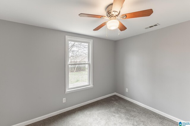 spare room with carpet floors and ceiling fan