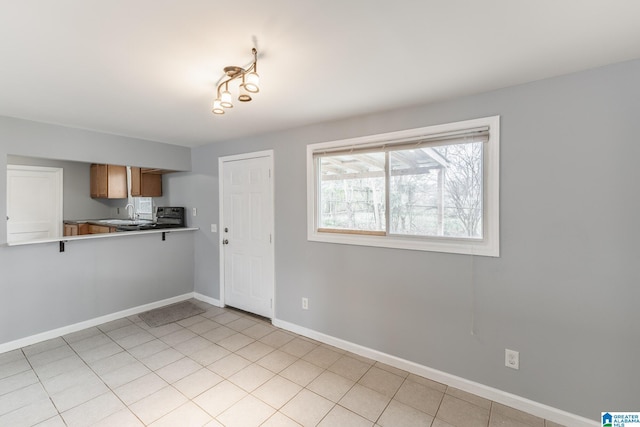 kitchen with sink and light tile patterned flooring