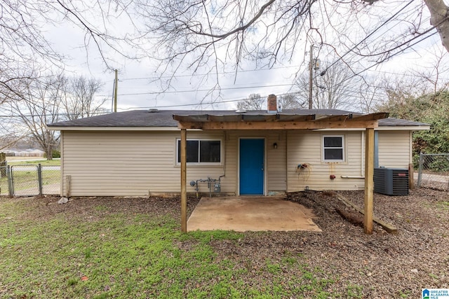 rear view of house with a yard, central AC unit, and a patio area