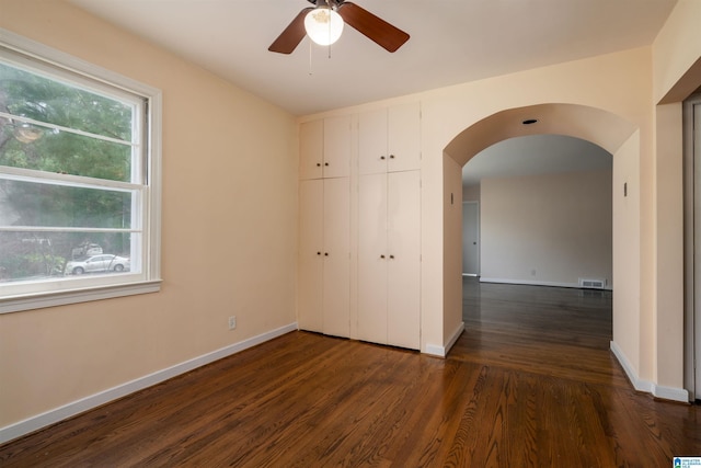 unfurnished bedroom featuring a closet and dark wood-type flooring