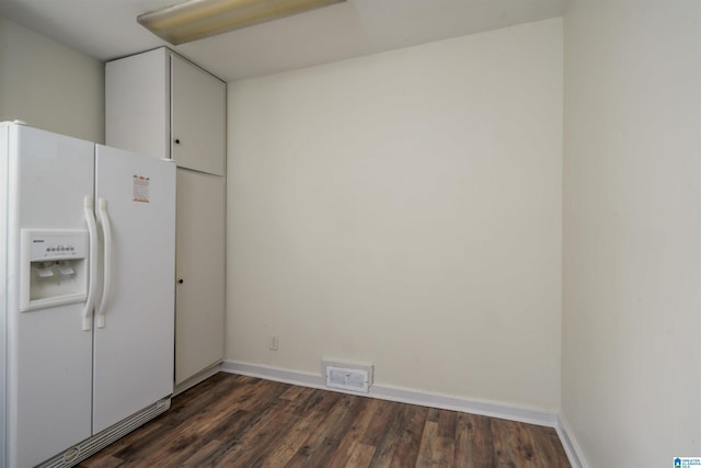 kitchen featuring white refrigerator with ice dispenser and dark hardwood / wood-style floors