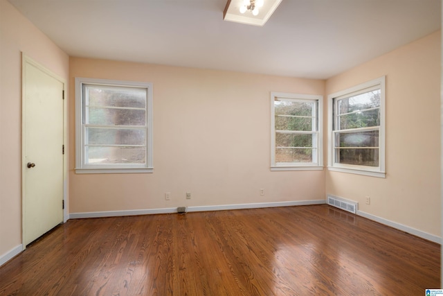 unfurnished room featuring dark hardwood / wood-style flooring