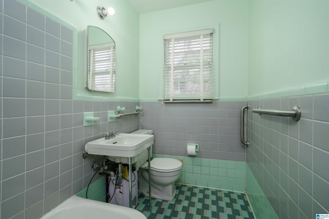 bathroom featuring tile walls, sink, tile patterned flooring, and toilet