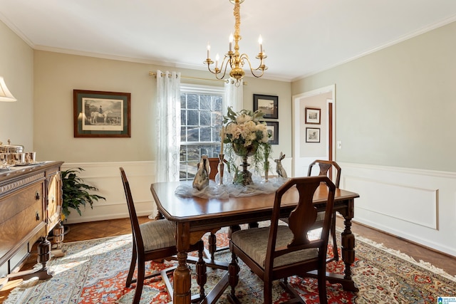 dining area featuring an inviting chandelier, parquet flooring, and ornamental molding