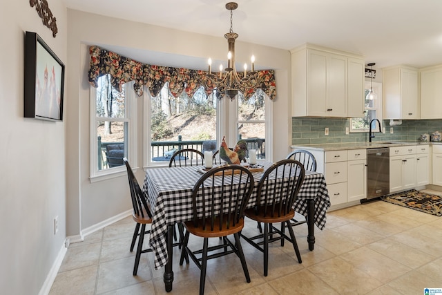 tiled dining room with sink, a chandelier, and a healthy amount of sunlight