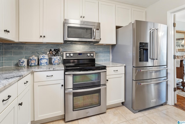 kitchen featuring light stone counters, white cabinets, and appliances with stainless steel finishes