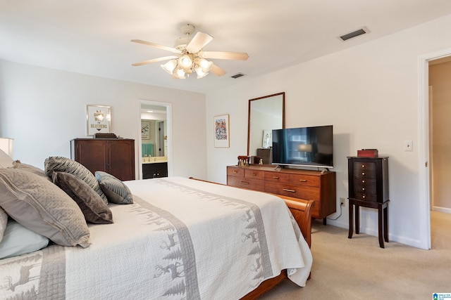 carpeted bedroom featuring ceiling fan and ensuite bath