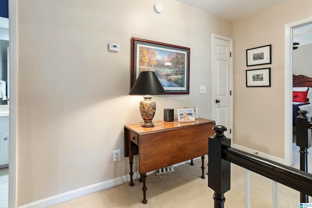 hallway with light colored carpet