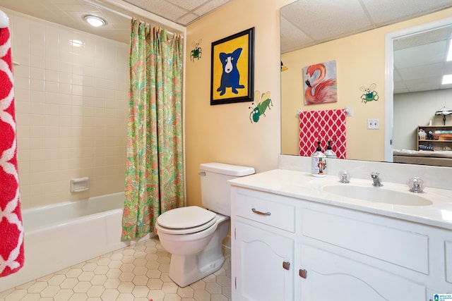 full bathroom with a paneled ceiling, vanity, toilet, tile patterned floors, and shower / bath combo with shower curtain