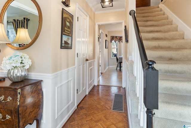 interior space featuring crown molding and parquet flooring