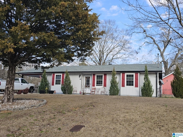 ranch-style house with a carport and a front lawn