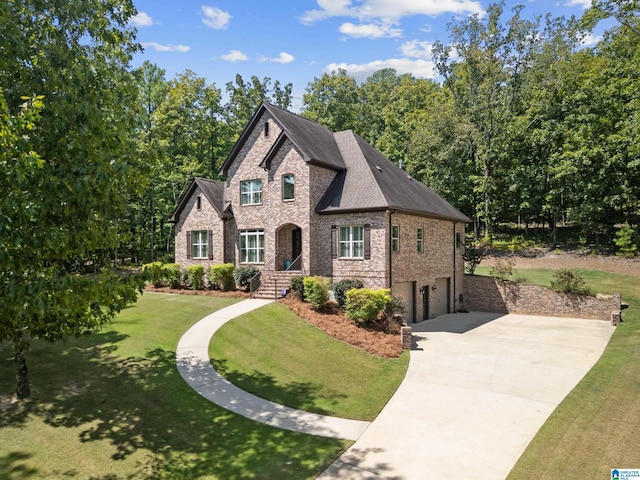 view of front of property with a garage and a front lawn